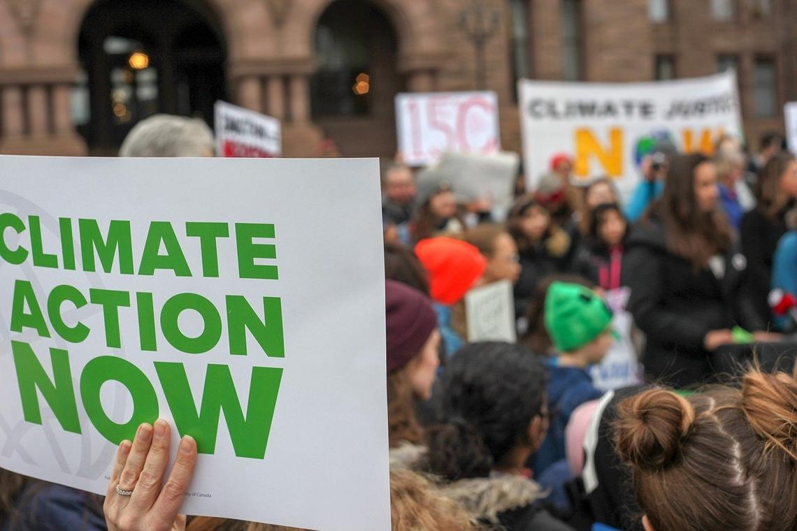 Protest sign saying 'Climate action now'