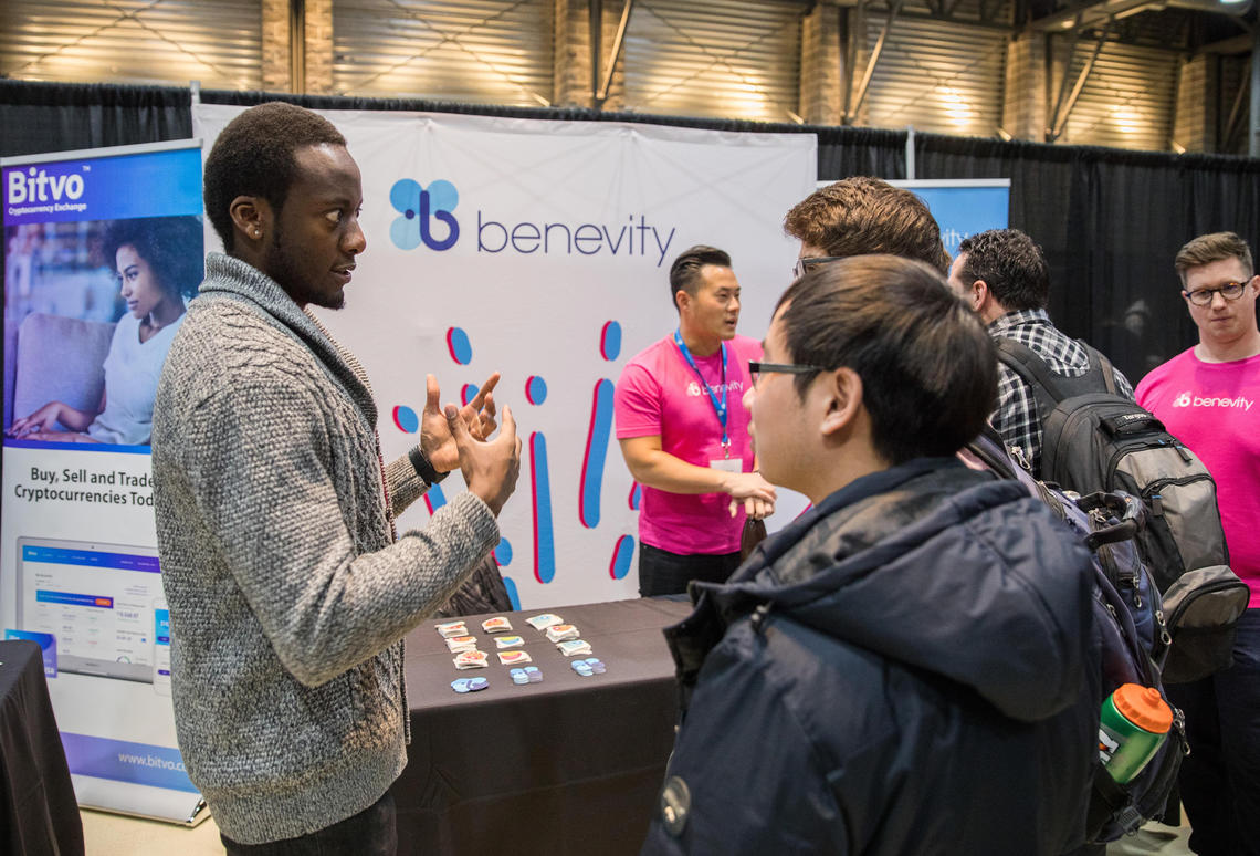 Students speak to Benevity reps at UCalgary Tech Fest.