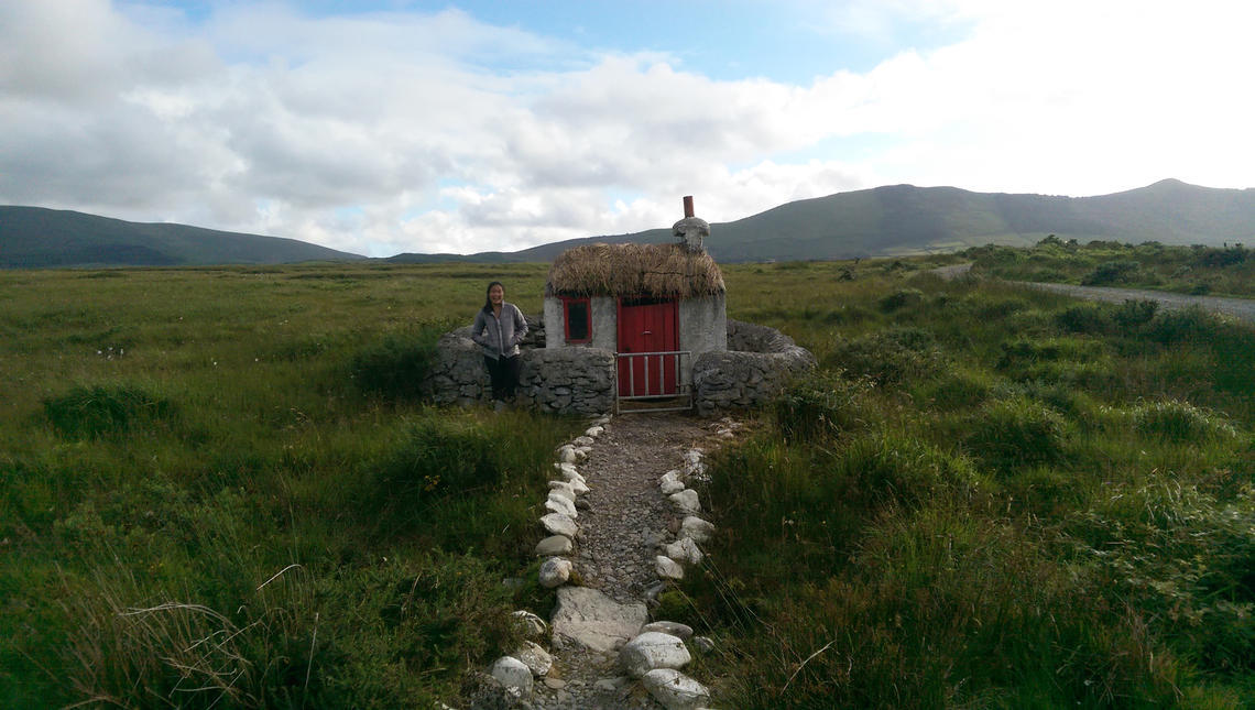 Karly Do stands near this tiny cottage on the route to Cahersiveen on the Ring of Kerry tourist trail in Ireland, one of the many hidden gems along the hike.