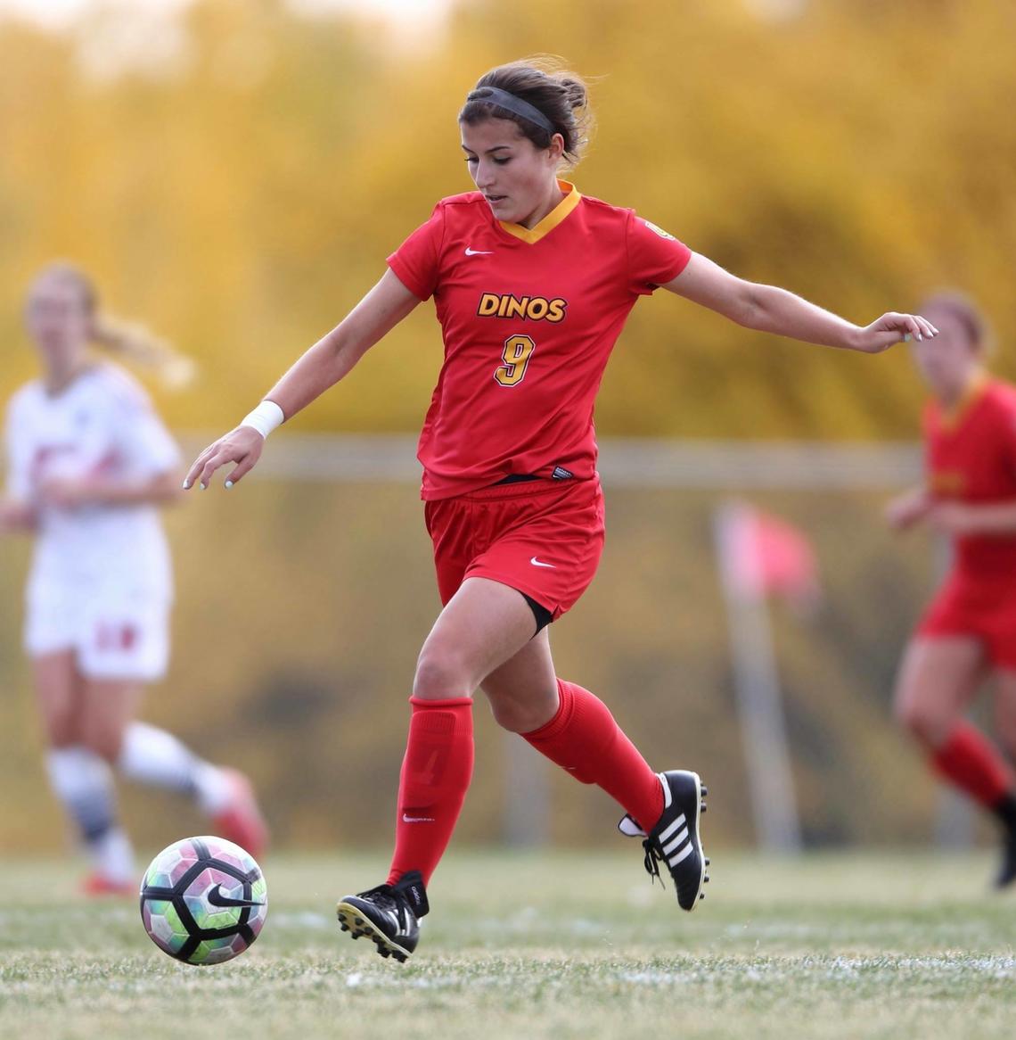 Kayla Kreutzer chases a soccer ball