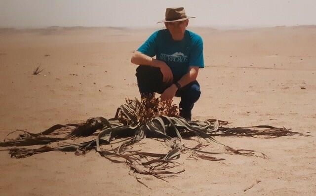 Isaac Rotstein next to a plant that only grows in the Namib desert of southern Africa. 