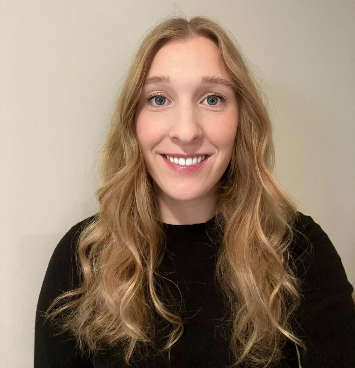 A headshot of a woman with long blonde hair