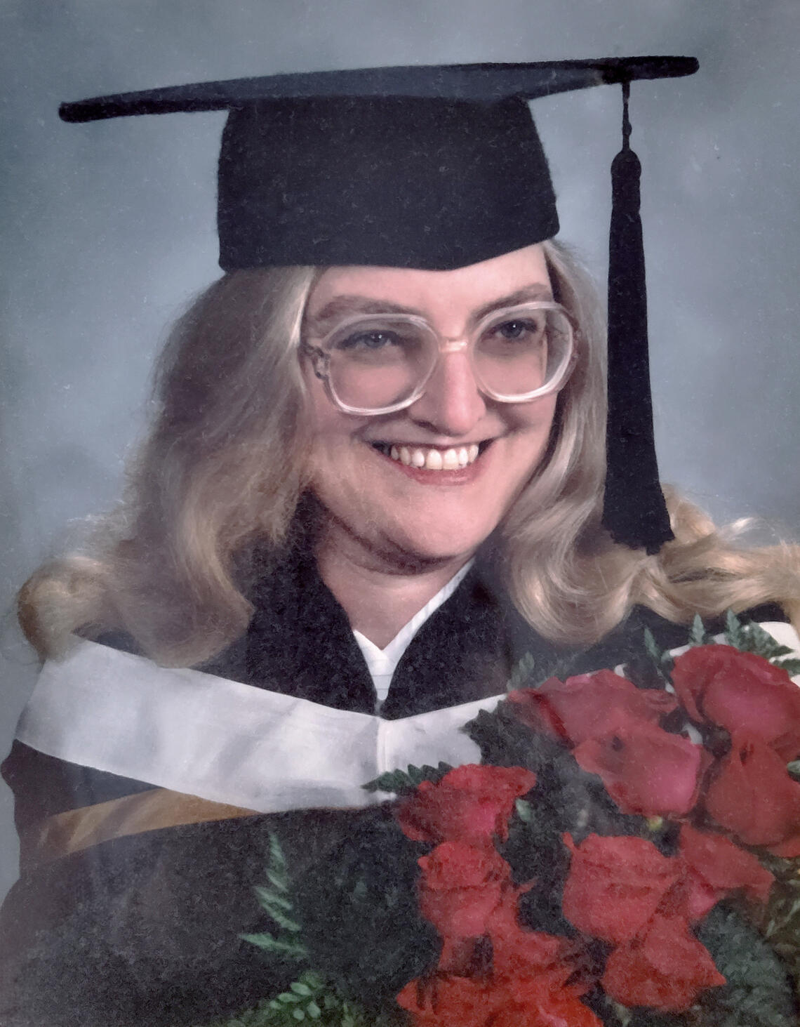 portrait of a woman in a graduation cap and gown