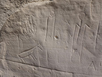 Ancient stone carvings are sometimes defaced with modern graffiti.