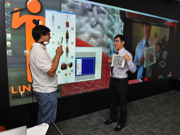 Shamsuddin Bhuiyan (left) and Isaac Lin demonstrate an augmented reality iPad application that is part of the LINDSAY Virtual Human project. 