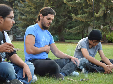 Student researcher Michael Broadfoot with the AIM-HI Network led overnight campers in a Talking Circle. Michael is a Métis person pursuing an education in Health and is an AIM-HI Network stipend awardee.