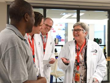 Christopher Simon, Dr. Bill Rosehart, Dr. Anders Nygren and Dr. Dru Marshall make their way through the engineering labs for their health and safety tour