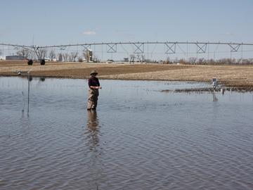 UCalgary hydrology grad student Alex Hughes takes measurements in a farmer’s field outside of Lethbridge on April 23