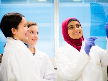 Dalia Abdelaziz, Eyes High Postdoctoral Fellow, works with Hailey Cox (left) and Tamia Duchesneau on a prion disease protein project