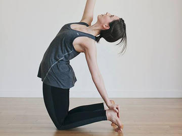 woman doing yoga alone in studio