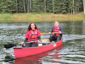 Students paddle in a canoe