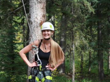 A student goes for a ride on the zip line