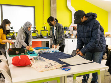 Sewing workshop participants choosing fabric