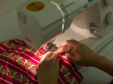 close up of a participant using a sewing machine