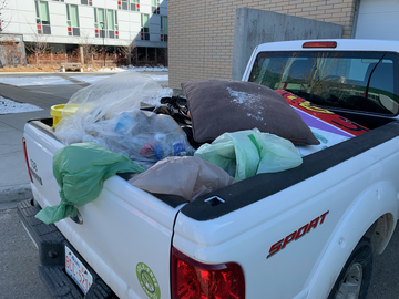 Back of a UCalgary vehicle filled with collected trash.