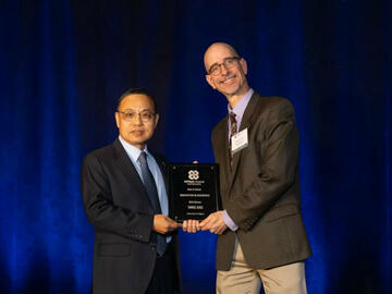Dr. Yang Gao accepting the award for Best in Sector: Aerospace