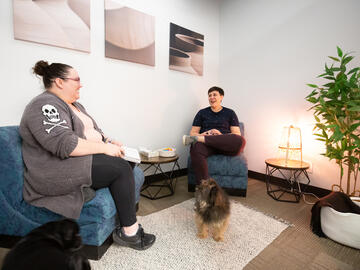 Staffers in conversation in a comfortable nook at UCalgary Recovery Community Hub