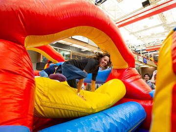 A person climbs through a bouncy obstacle course
