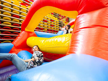 A person climbs through a bouncy castle