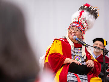 An Indigenous elder wearing a traditional headdress
