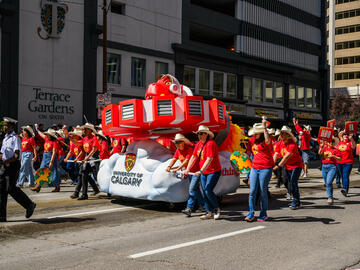 Space Rex float and UCalgary volunteers marching at the Stampede Parade. 
