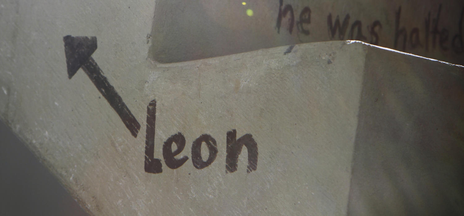 Sideview of the Social Sciences stairs featuring the original Leon the Frog poem. The name "Leon" is writen in black marker, with an arrow pointing upwwards.