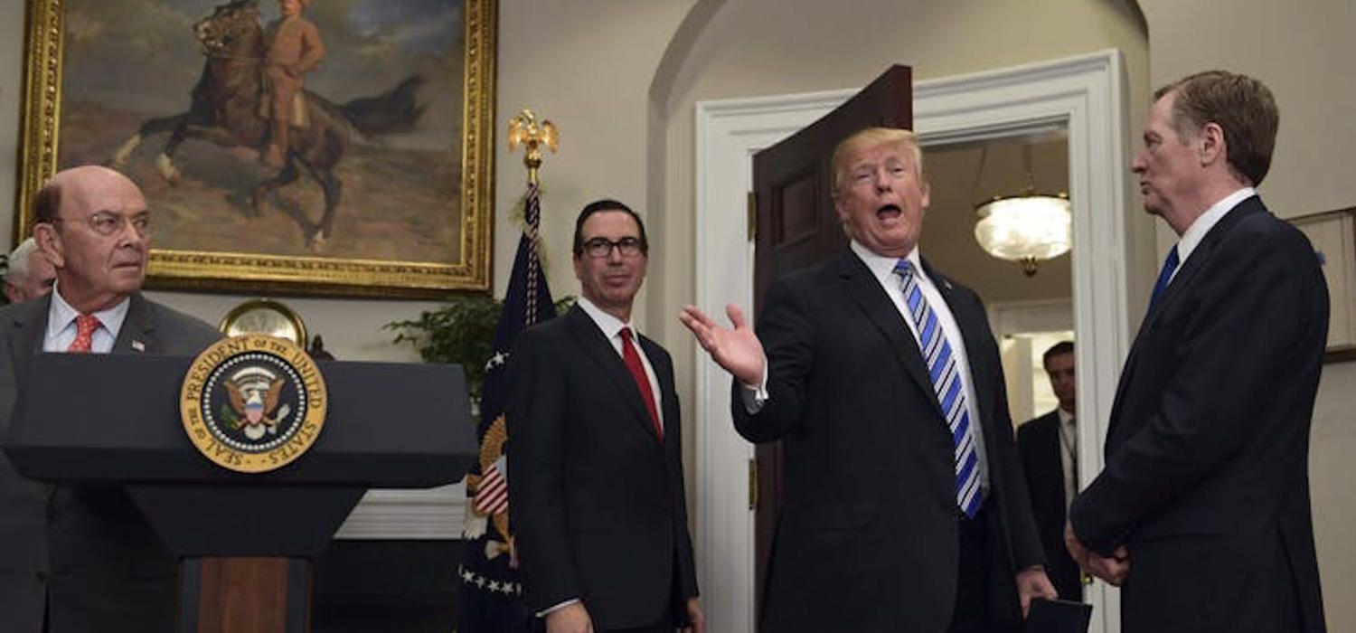 President Donald Trump makes a comment at the White House in March 2018, when he signed proclamations on steel and aluminum imports. Watching as Trump leaves are, from left, Commerce Secretary Wilbur Ross, Treasury Secretary Steven Mnuchin and U.S. Trade Representative Robert Lighthizer. 