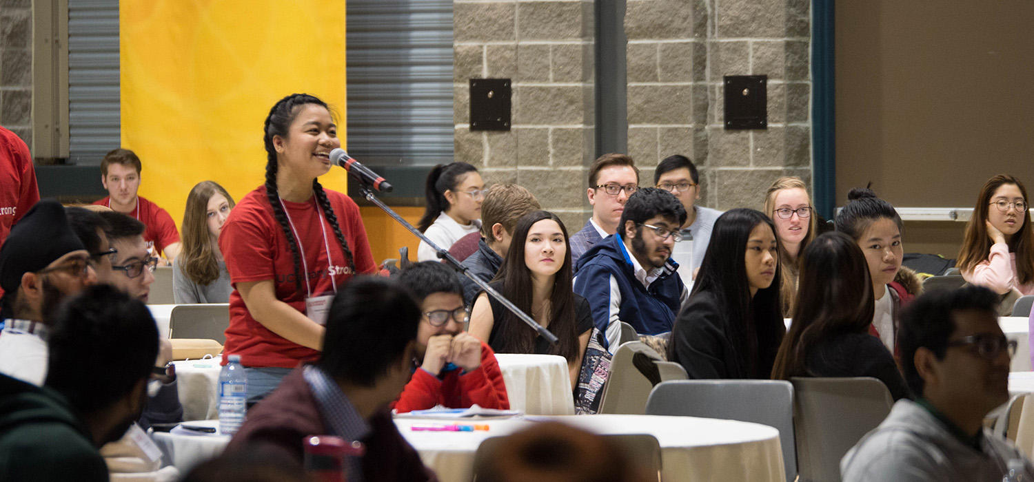 A business student asks a question during the keynote speaker session at a previous conference. 
