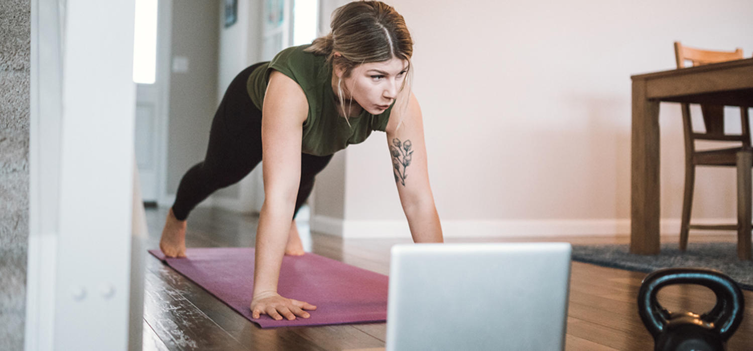 woman working out in front of laptop