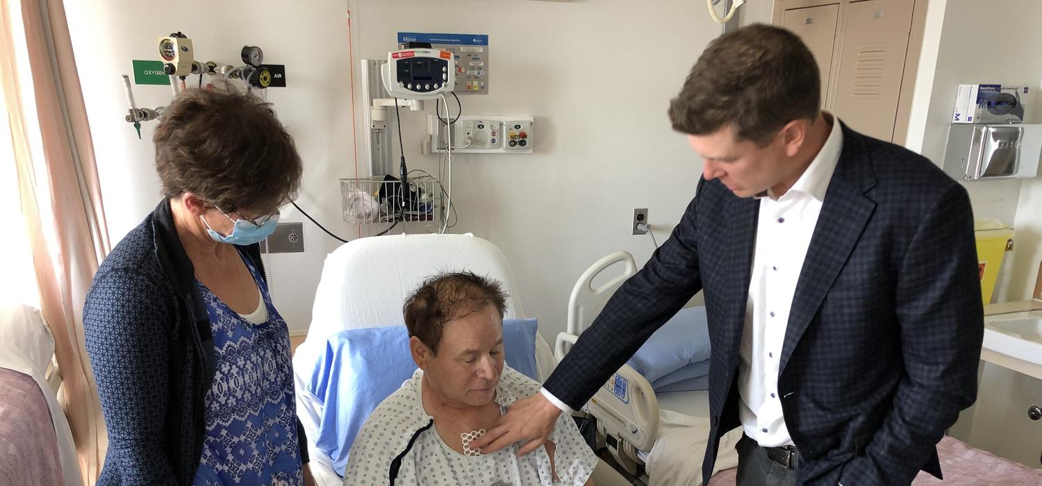 Dr. Corey Adams checks up on Darrell Parker, who underwent five heart bypass procedures.