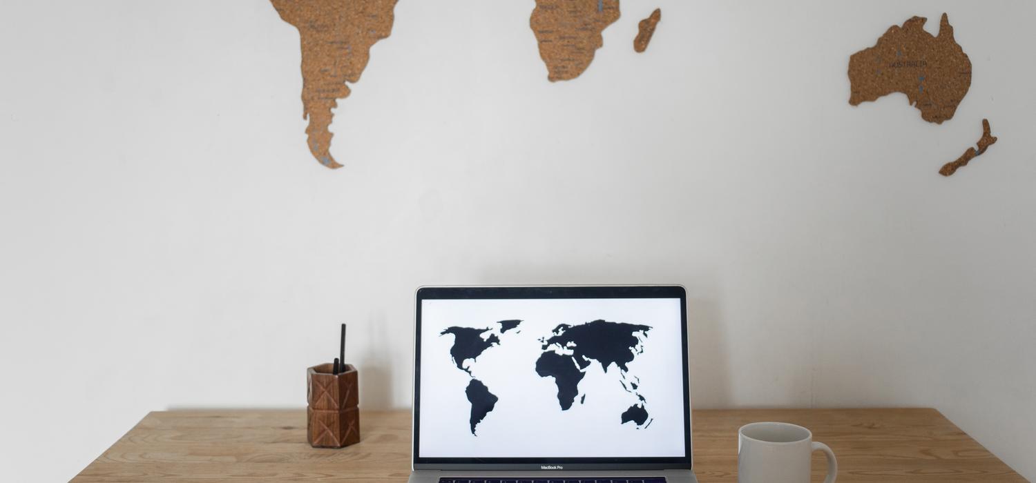 A laptop with a map on the screen on top of desk