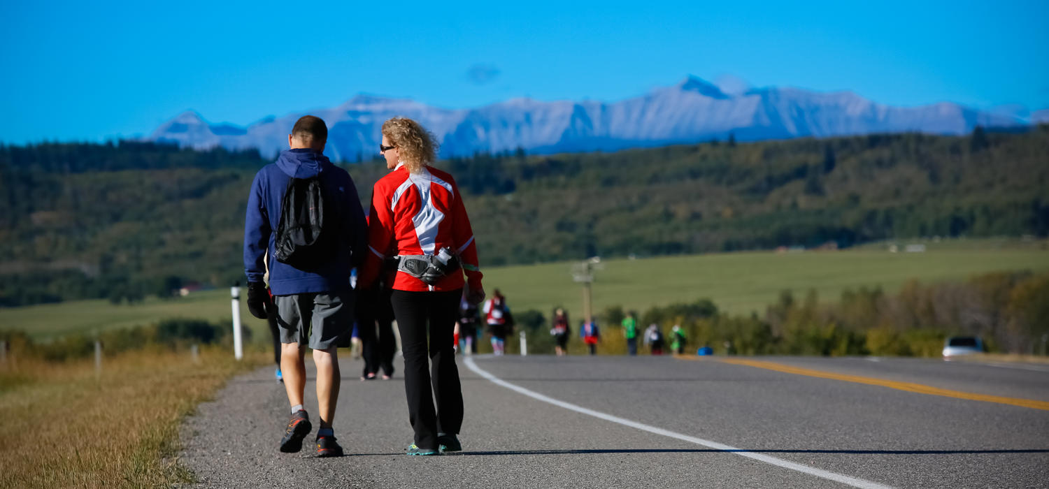 Dean Sandra Davidson and husband Jim walk down road