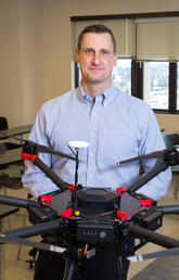 Chris Hugenholtz, an associate professor in the Department of Geography, seen here with his drone technology, is director and head researcher of the newly established Centre For Smart Emissions Sensing Technologies. Photo by Riley Brandt, University of Calgary