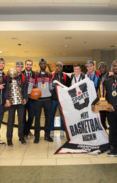Victorious Dinos pose for posterity at the Calgary airport after their historic win.