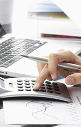 Closeup of hand and calculator