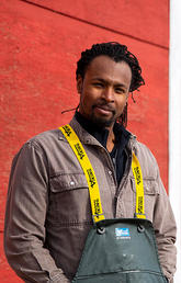 Tatenda Mambo stands in front of a barn