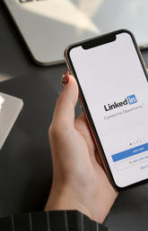 A user opening LinkedIn on their iPhone