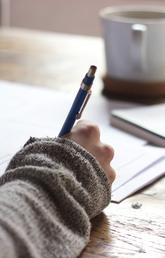 Stock photo of person writing