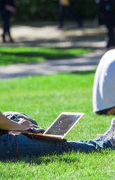 Student relaxing on the lawn