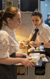 Staff members work at a newly opened fast-food restaurant in a former McDonald’s outlet in June 2022 in Moscow. It offers most of the same items as McDonald’s and is an example of how Russia is defying western sanctions.