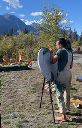 Megan Leung painting during her artist residency at Kluane Lake Research Station