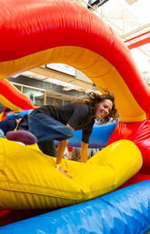 A person jumps over a bouncy castle