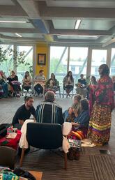 People gather in the lodge for a pipe ceremony.