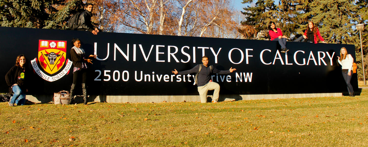 Image of exchange students in front of UCalgary sign