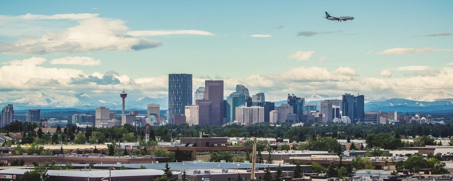 Image of an airplane over the Calgary skyline