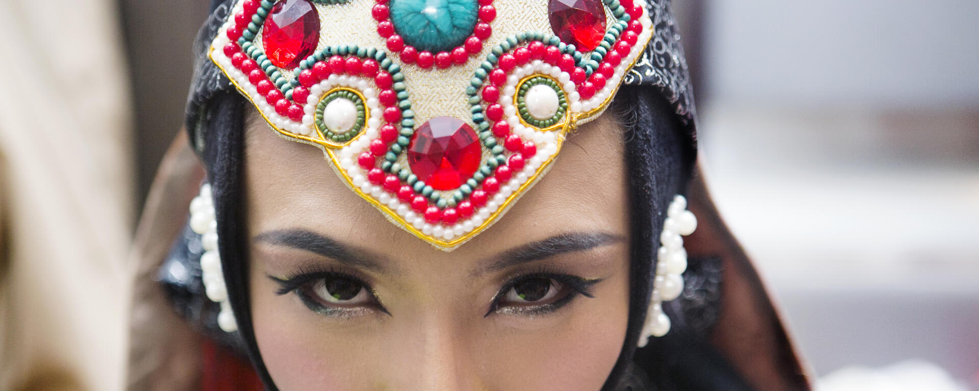a trans-woman performer in Mongolia wearing a traditional headdress