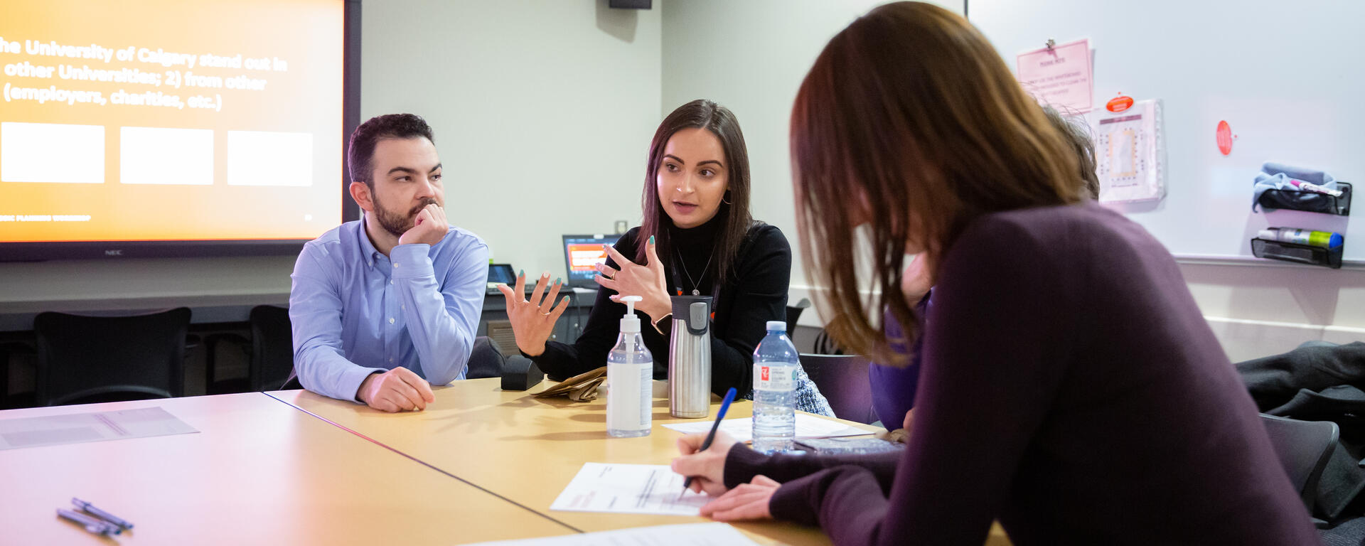 Group of people gathered at a table during one of the strategic planning workshops in February.