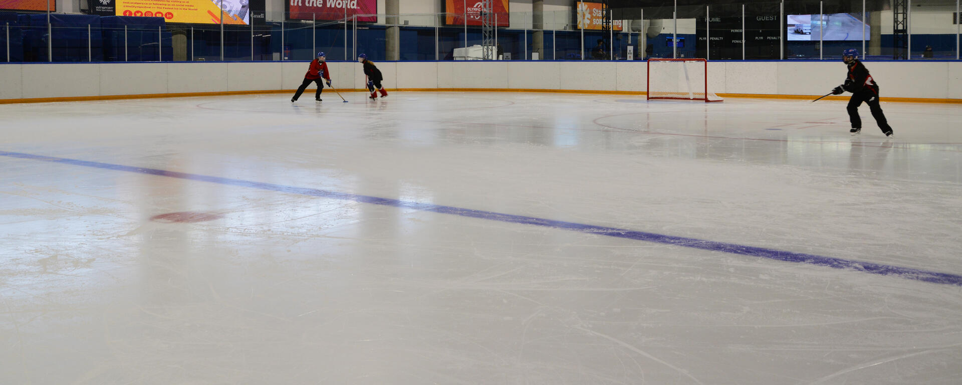 Ringette players performing a drill on-ice