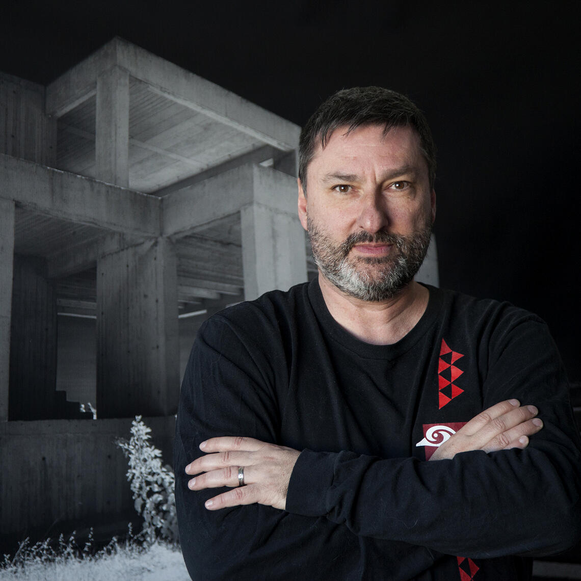 man standing against dark background