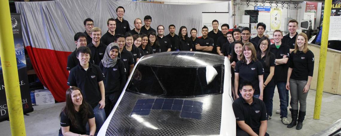 Students pose with solar car Students pose with solar car